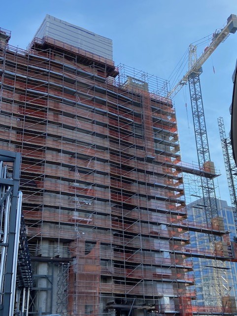 Scaffolding around a building with a Crane