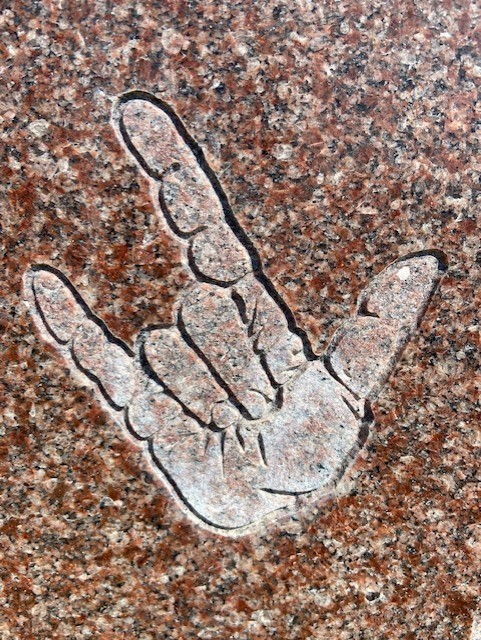 I love you sign language on stone.