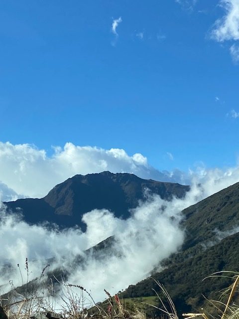 Mountain with white clouds floating above